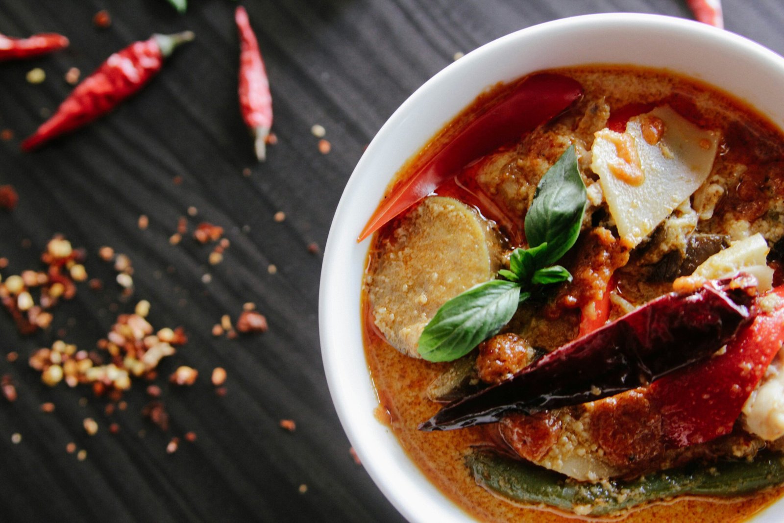 flat-lay photography of vegetable soup on white ceramic cup